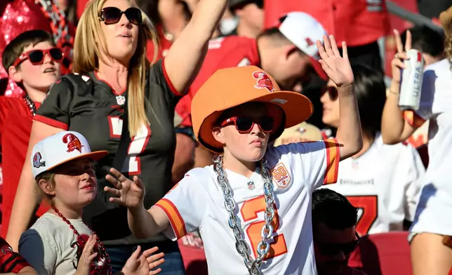 Tampa Bay Buccaneers fans cheer on their team during the second half of an NFL football game against the Arizona Cardinals Sunday, Nov. 30, 2025, in Tampa, Fla. (AP Photo/Jason Behnken)