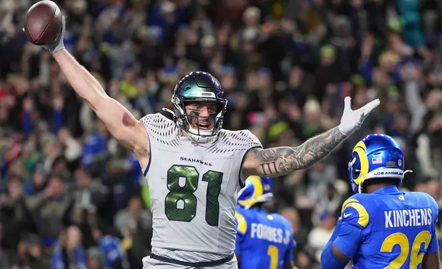 Seattle Seahawks tight end Eric Saubert (81) celebrates after making a two-point conversion during overtime in an NFL football game against the Los Angeles Rams, Thursday, Dec. 18, 2025, in Seattle. (AP Photo/Lindsey Wasson)