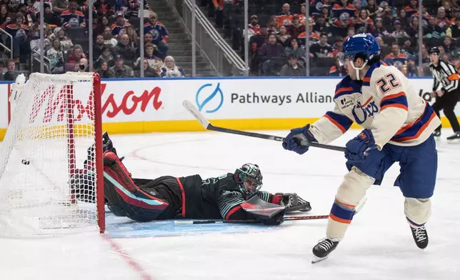 Seattle Kraken goalie Joey Daccord (35) is scored on by Edmonton Oilers' Matt Savoie (22) during second period NHL action, in Edmonton on Thursday, December 4, 2025. (Jason Franson/The Canadian Press via AP)