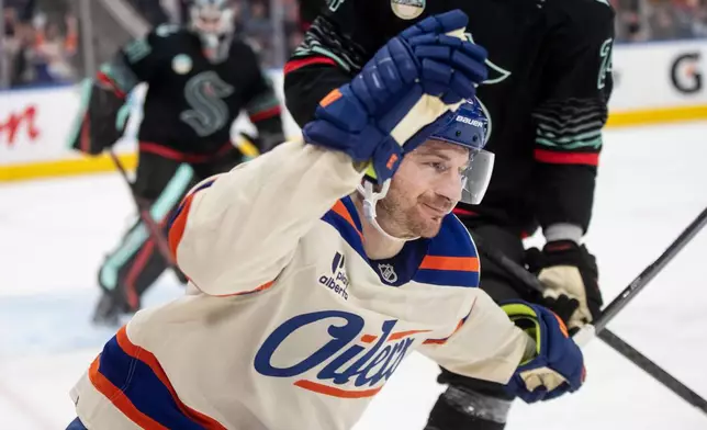 Edmonton Oilers' Zach Hyman (18) celebrates a goal against the Seattle Kraken during second period NHL action, in Edmonton on Thursday, Dec. 4, 2025. (Jason Franson/The Canadian Press via AP)