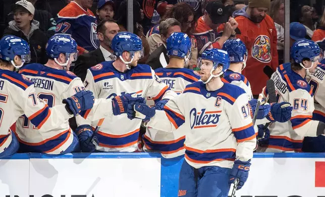 Edmonton Oilers' Connor McDavid (97) celebrates after a goal against the Seattle Kraken during first-period NHL hockey game action in Edmonton, Alberta, Thursday, Dec. 4, 2025. (Jason Franson/The Canadian Press via AP)