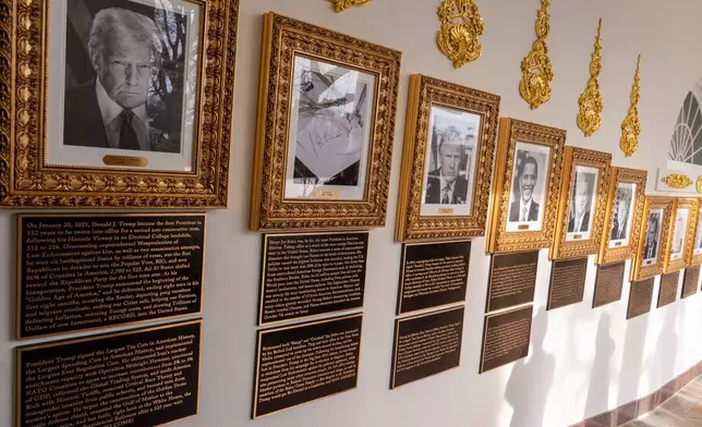 New plaques of explanatory text have been placed underneath presidential portraits on the Colonnade at the White House, Wednesday, Dec. 17, 2025, in Washington. (AP Photo/Alex Brandon)