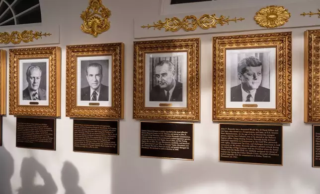 New plaques of explanatory text have been placed underneath presidential portraits on the Colonnade at the White House, Wednesday, Dec. 17, 2025, in Washington. (AP Photo/Alex Brandon)