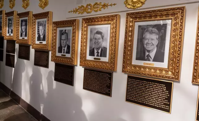 New plaques of explanatory text have been placed underneath presidential portraits on the Colonnade at the White House, Wednesday, Dec. 17, 2025, in Washington. (AP Photo/Alex Brandon)