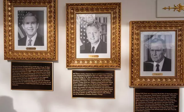 New plaques of explanatory text have been placed underneath presidential portraits on the Colonnade at the White House, Wednesday, Dec. 17, 2025, in Washington. (AP Photo/Alex Brandon)