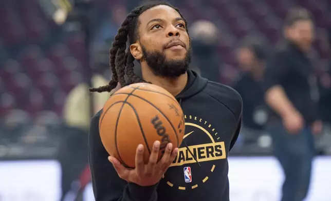 Cleveland Cavaliers' Darius Garland warms up before an NBA basketball game against the Charlotte Hornets in Cleveland, Sunday, Dec. 14, 2025. (AP Photo/Phil Long)