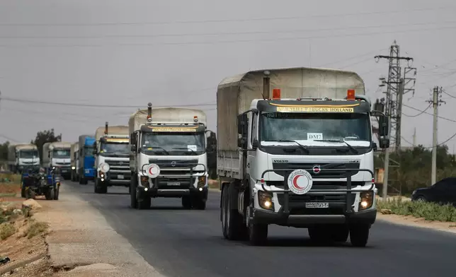 FILE - A convoy of vehicles loaded with food and other aid is en route to Sweida on the international highway in rural Daraa province, Syria, July 20, 2025, heading to the city of Busra al-Sham. (AP Photo/Omar Sanadiki, File)