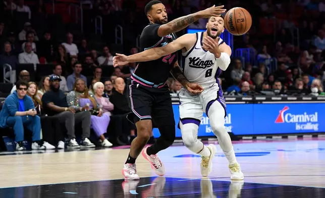 Sacramento Kings guard Zach Lavine (8) tries to control the ball against Miami Heat guard Norman Powell (24) during the first half of an NBA basketball game, Saturday, Dec. 6, 2025, in Miami. (AP Photo/Michael Laughlin)
