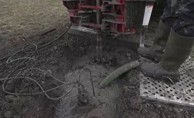 A drill bit spins into the earth during a geothermal heat pump installation Thursday, Oct. 9, 2025, in Hamilton, Colo. (AP Photo/Brittany Peterson)