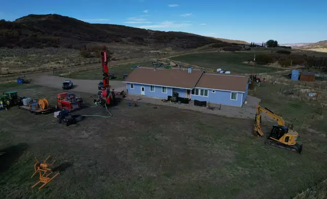A drill sits outside the Cooper family ranch as they work to install a geothermal heat pump Thursday, Oct. 9, 2025, in Hamilton, Colo. (AP Photo/Brittany Peterson)