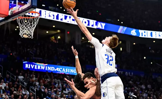 Dallas Mavericks forward Cooper Flagg (32) shoots against Oklahoma City Thunder during the first half of an NBA basketball game, Friday, Dec. 5, 2025, in Oklahoma City. (AP Photo/Gerald Leong)
