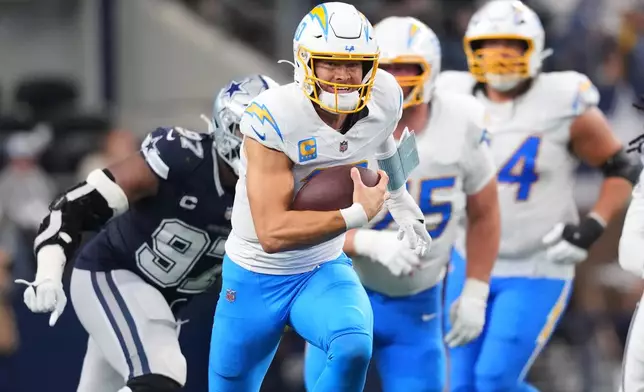 Los Angeles Chargers quarterback Justin Herbert (10) runs during the second half of an NFL football game against the Dallas Cowboys, Sunday, Dec. 21, 2025, in Arlington, Texas. (AP Photo/Julio Cortez)