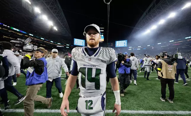 Seattle Seahawks quarterback Sam Darnold (14) walks on the field after an NFL football game against the Los Angeles Rams, Thursday, Dec. 18, 2025, in Seattle. (AP Photo/John Froschauer)