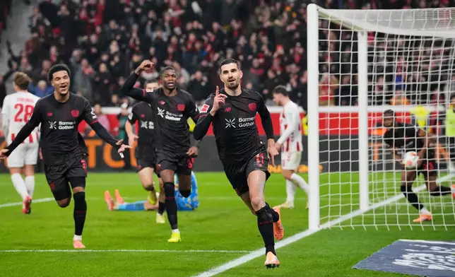 Leverkusen's Martin Terrier celebrates after he scored the opening goal during the German Bundesliga soccer match between Bayer 04 Leverkusen and 1.FC Cologne in Leverkusen, Germany, Saturday, Dec. 13, 2025. (AP Photo/Martin Meissner)
