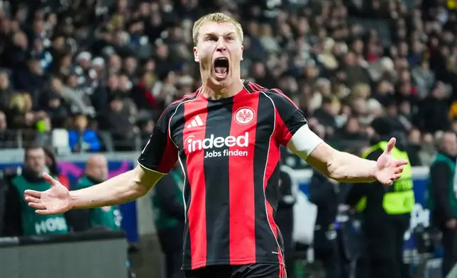 Frankfurt's Rasmus Kristensen celebrates at the end of the German Bundesliga soccer match between Eintracht Frankfurt and FC Augsburg in Frankfurt, Germany, Saturday, Dec. 13, 2025. (Marc Schueler/dpa via AP)