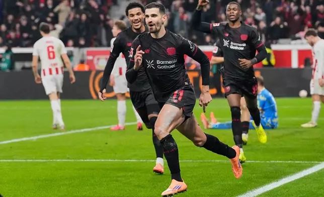 Leverkusen's Martim Terrier celebrates after he scored the opening goal during the German Bundesliga soccer match between Bayer 04 Leverkusen and 1.FC Cologne in Leverkusen, Germany, Saturday, Dec. 13, 2025. (AP Photo/Martin Meissner)