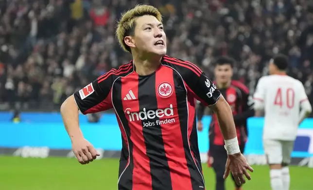 Frankfurt's Ritsu Doan celebrates after scoring the opening goal during the German Bundesliga soccer match between Eintracht Frankfurt and FC Augsburg in Frankfurt, Germany, Saturday, Dec. 13, 2025. (Marc Schueler/dpa via AP)