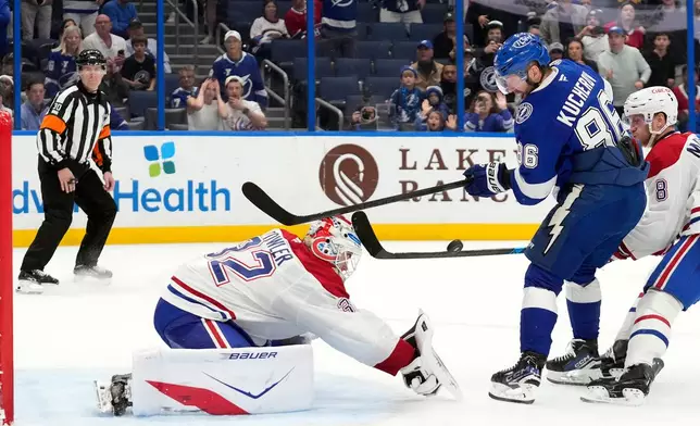 Montréal Canadiens goaltender Jacob Fowler (32) stops a shot by Tampa Bay Lightning right wing Nikita Kucherov (86) during overtime in an NHL hockey game Sunday, Dec. 28, 2025, in Tampa, Fla. (AP Photo/Chris O'Meara)