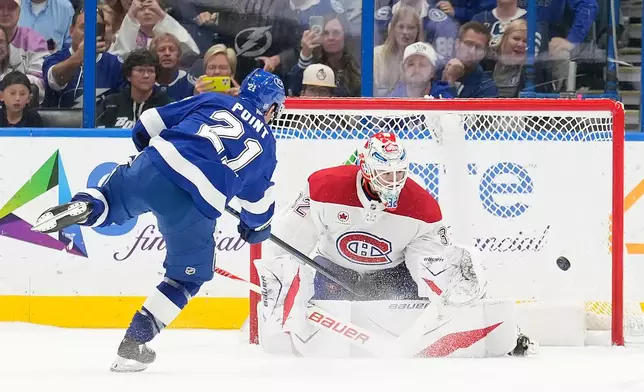 Tampa Bay Lightning center Brayden Point (21) scores past Montréal Canadiens goaltender Jacob Fowler (32) during a shootout in an NHL hockey game Sunday, Dec. 28, 2025, in Tampa, Fla. (AP Photo/Chris O'Meara)