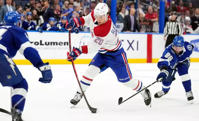 Montréal Canadiens left wing Juraj Slafkovský (20) prepares to score after getting around Tampa Bay Lightning right wing Nikita Kucherov (86) during the third period of an NHL hockey game Sunday, Dec. 28, 2025, in Tampa, Fla. (AP Photo/Chris O'Meara)
