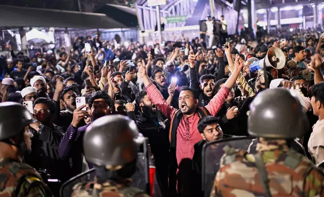 Protesters shout slogans in front of the premises of the Prothom Alo daily newspaper after news reached the country from Singapore of the death of a prominent activist Sharif Osman Hadi, in Dhaka, Bangladesh, Friday, Dec. 19, 2025. (AP Photo/Mahmud Hossain Opu)