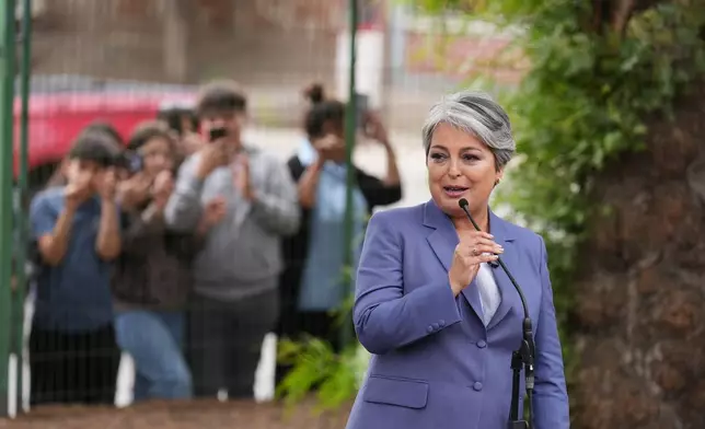 Jeannette Jara, presidential candidate of the ruling Unity for Chile coalition, speaks after voting during the presidential runoff election in Santiago, Chile, Sunday, Dec. 14, 2025. (AP Photo/Natacha Pisarenko)