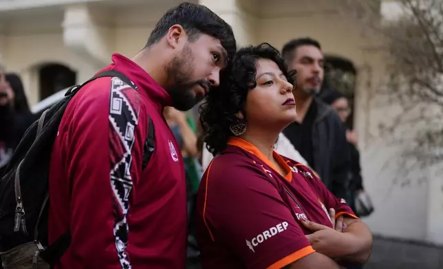 Supporters react to early results at the campaign headquarters of Jeannette Jara, presidential candidate of the ruling Unity for Chile coalition, in Santiago, Chile, Sunday, Dec. 14, 2025. (AP Photo/Natacha Pisarenko)