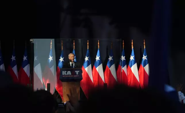 Presidential candidate Jose Antonio Kast of the Republican Party addresses supporters, from behind a protective glass panel, during a rally ahead of the runoff election in Temuco, Chile, Thursday, Dec. 11, 2025. (AP Photo/Esteban Felix)