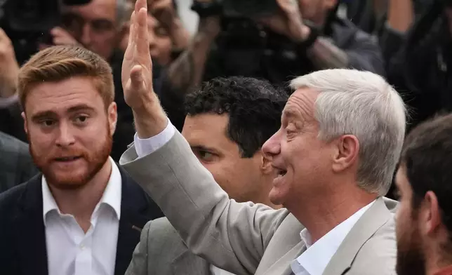 Jose Antonio Kast, presidential candidate for the Republican Party, waves after voting in the presidential runoff election in Santiago, Chile, Sunday, Dec. 14, 2025. (AP Photo/Esteban Felix)
