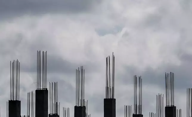 A worker walks through a building under construction in Georgetown, Guyana, Sept. 2, 2025. (AP Photo/Matias Delacroix, File)