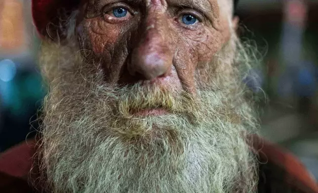 Eugene Graham watches as protesters stand off against police and federal officers at a U.S. Immigration and Customs Enforcement facility in Portland, Ore., Oct. 5, 2025. (AP Photo/Ethan Swope, File )