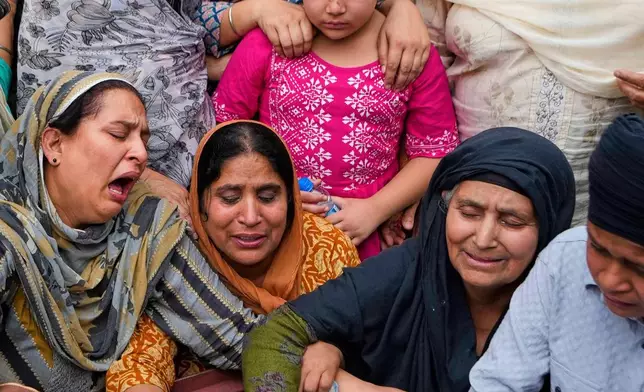 Relatives mourn near the body of Amarjeet Singh, 51, killed in Pakistani artillery shelling in Poonch along the Line of Control, Indian-controlled Kashmir, May 8, 2025. (AP Photo/Channi Anand, File)