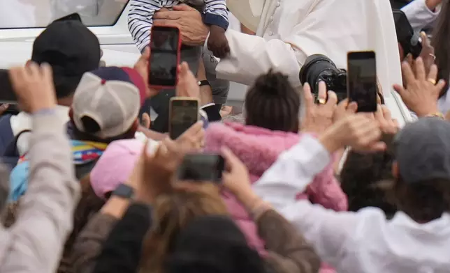 Pope Leo XIV blesses a child at the end of a Mass for the Jubilee of Migrants and Missionaries in St. Peter's Square at the Vatican, Oct. 5, 2025. (AP Photo/Alessandra Tarantino,File)