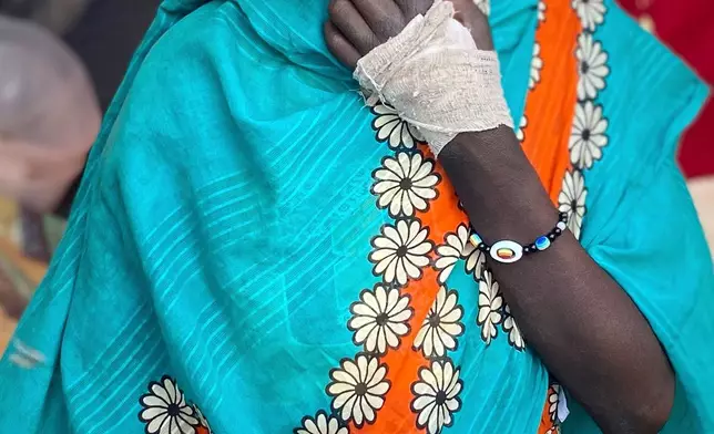 An injured Sudanese woman who fled el-Fasher city, after Sudan's paramilitary forces killed hundreds of people in the western Darfur region, sits in a tent at a camp in Tawila, Sudan, Oct. 31, 2025. (AP Photo/Mohammed Bakry, File)