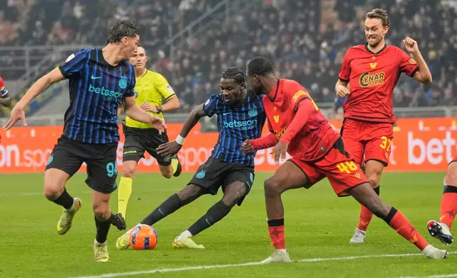 Inter Milan's Marcus Thuram, 2nd left, scores his side's third goal during the Italian soccer cup round of sixteen match between Inter Milan and Venezia, at the San Siro stadium in Milan, Italy, Wednesday, Dec.3, 2025. (AP Photo/Luca Bruno)