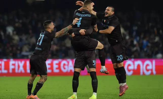 Napoli's Alessandro Buongiorno, top, celebrates after scoring during the round of sixteen Italian Cup soccer match between Napoli and Cagliari in Naples, Italy, Wednesday, Dec. 3, 2025. (Alessandro Garofalo/LaPresse via AP)