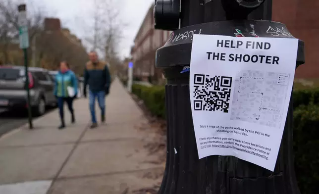 A poster seeking information about the campus shooting suspect is seen on the campus of Brown University, Wednesday, Dec. 17, 2025, in Providence, R.I. (AP Photo/Robert F. Bukaty)