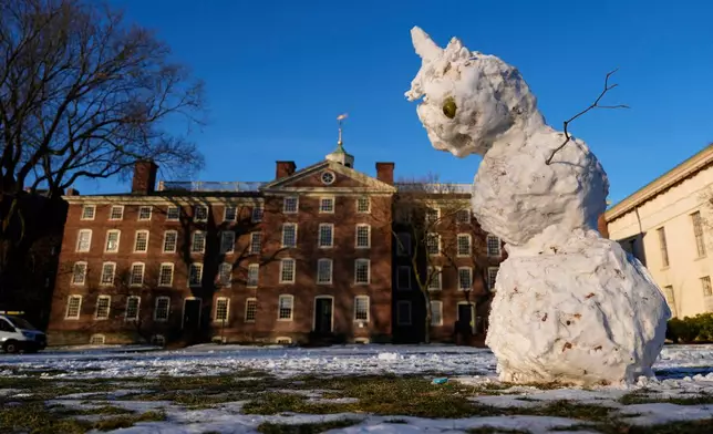 A snowman begins to sag on the usually-bustling Main Green at Brown University, where the fall semester was canceled a week early following the campus shooting, Wednesday, Dec. 17, 2025, in Providence, R.I. (AP Photo/Robert F. Bukaty)