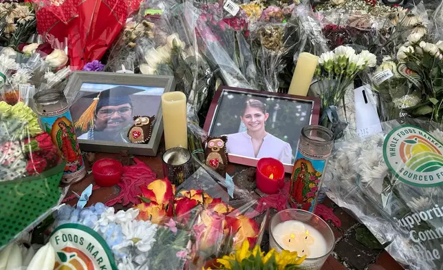 Flowers and candles surround photos of Mukhammad Aziz Umurzokov, an 18-year-old freshman from Brandermill, Va., and Ella Cook, a 19-year-old sophomore from a suburb of Birmingham, Ala., in front of a Brown University gate in Providence, R.I., on Wednesday, Dec. 17, 2025. (AP Photo/Leah Willingham)