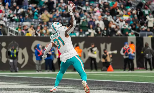 Miami Dolphins running back Ollie Gordon II (31) reacts after scoring a touchdown against the New York Jets during the fourth quarter of an NFL football game, Sunday, Dec. 7, 2025, in East Rutherford, N.J. (AP Photo/Yuki Iwamura)