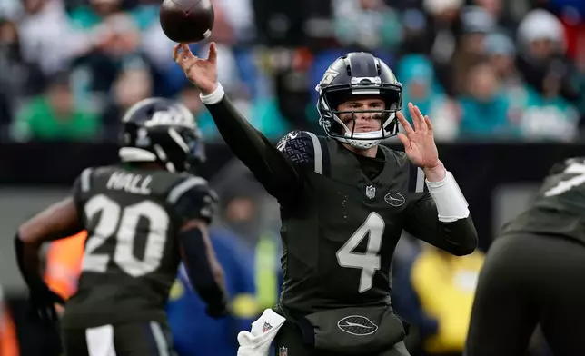 New York Jets quarterback Brady Cook (4) passes against the Miami Dolphins during the fourth quarter of an NFL football game, Sunday, Dec. 7, 2025, in East Rutherford, N.J. (AP Photo/Adam Hunger)