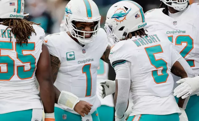 Miami Dolphins quarterback Tua Tagovailoa (1) reacts during the first quarter of an NFL football game against the New York Jets, Sunday, Dec. 7, 2025, in East Rutherford, N.J. (AP Photo/Adam Hunger)