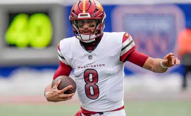 Washington Commanders quarterback Marcus Mariota (8) carries the ball against the New York Giants during the first quarter of an NFL football game, Sunday, Dec. 14, 2025, in East Rutherford, N.J. (AP Photo/Seth Wenig)