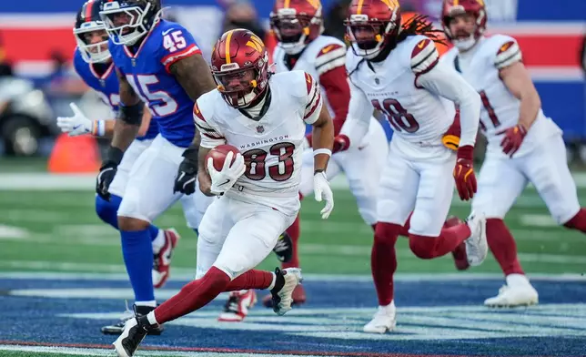 Washington Commanders wide receiver Jaylin Lane (83) carries the ball for a touchdown against the New York Giants during the second quarter of an NFL football game, Sunday, Dec. 14, 2025, in East Rutherford, N.J. (AP Photo/Seth Wenig)
