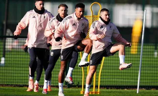 Aston Villa's Emi Buendia, Ollie Watkins and Matty Cash during a training session at Bodymoor Heath Training Ground, in Tamworth, England, Wednesday Dec. 10, 2025. (Jacob King/PA via AP)