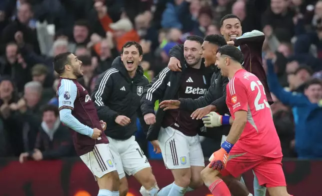 Aston Villa players celebrate after Aston Villa's Emiliano Buendia, left, scored his side's second goal during the English Premier League soccer match between Aston Villa and Arsenal in Birmingham, England, Saturday, Dec. 6, 2025. (AP Photo/Dave Shopland)