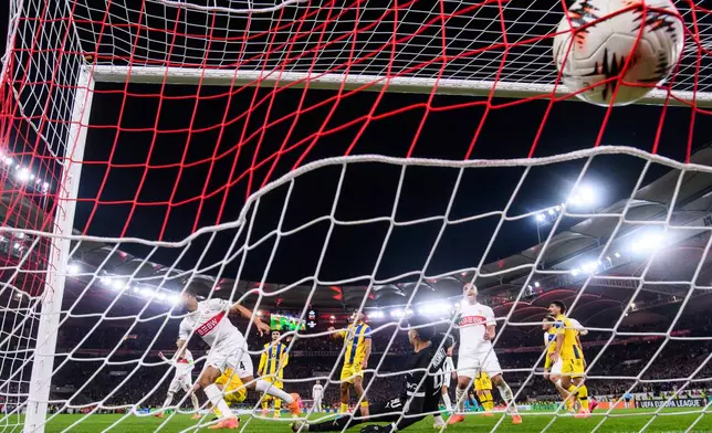 Stuttgart's Josha Vagnoman, left, scores his side's fourth goal during the Europa League opening phase soccer match between VfB Stuttgart and Maccabi Tel-Aviv FC in Stuttgart, Germany, Thursday, Dec. 11, 2025. (Tom Weller/dpa via AP)