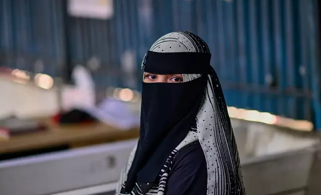 Hasina, a Rohingya refugee girl, sits inside the Rohingya refugee camp in Cox's Bazar, Bangladesh, Thursday, Nov. 20, 2025. (AP Photo/Mahmud Hossain Opu)