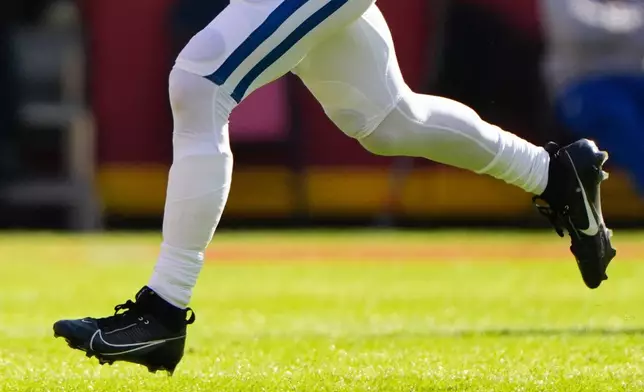 FILE - Indianapolis Colts quarterback Daniel Jones, wearing a special pad on his lower left leg, runs for a first down against the Kansas City Chiefs during the first half of an NFL football game Sunday, Nov. 23, 2025, in Kansas City, Mo. (AP Photo/Charlie Riedel, File)