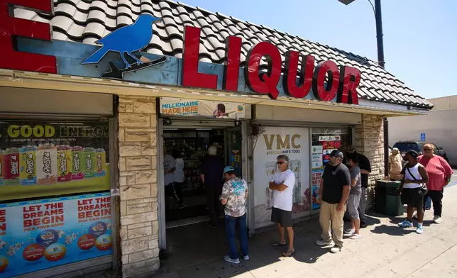 FILE - People wait in line to purchase lottery tickets outside Bluebird Liquor store in Hawthorne, Calif., on Friday, Sept. 5, 2025. (AP Photo/Damian Dovarganes, File)
